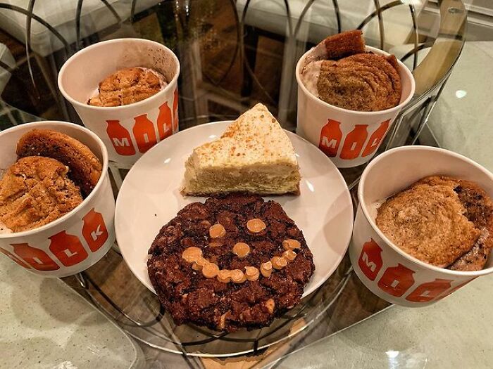 An Assortment Of Cookies And A Slice Chessecake To 