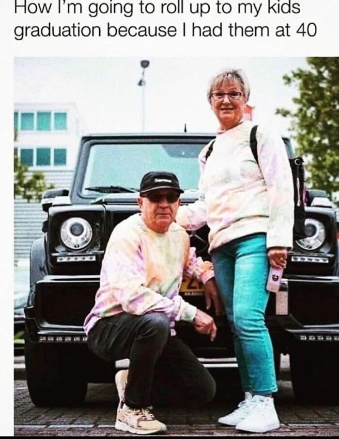 Older couple with a luxury car, dressed in colorful outfits, humorously representing late parenthood milestones.