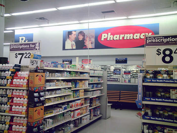 Pharmacy interior with shelves stocked with medications and signs, illustrating discussions about conspiracy theories.