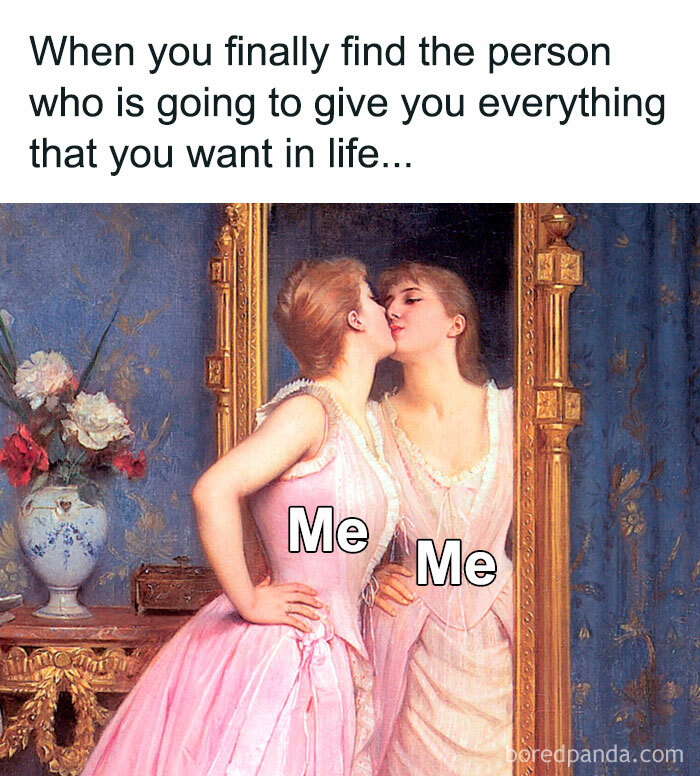 Woman in pink dress kissing her reflection in a mirror, illustrating a humorous meme about being single.