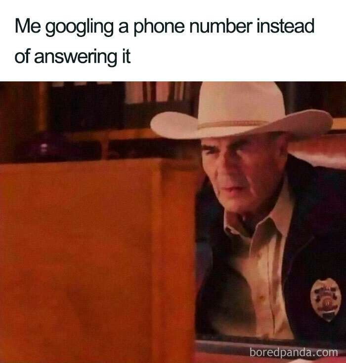 Man in cowboy hat looking closely at a computer screen illustrating funny introvert meme about avoiding phone calls.