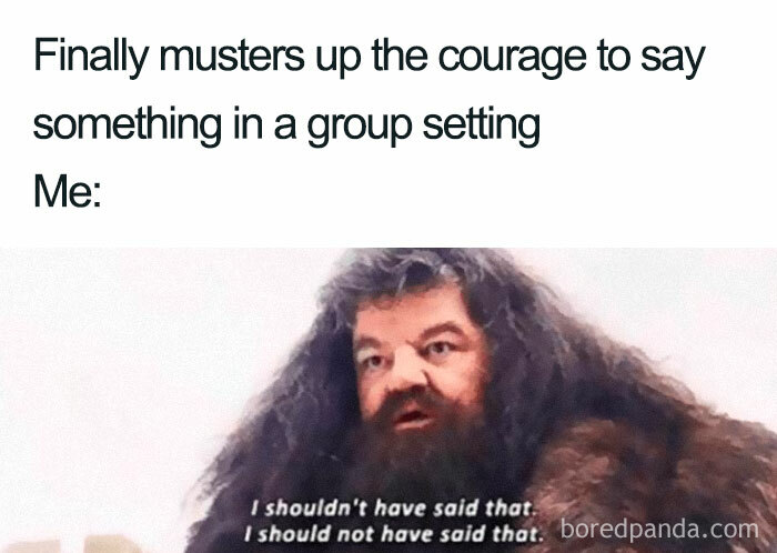 Man with long hair and beard looking regretful, illustrating an introvert’s hesitation after speaking in a group setting.