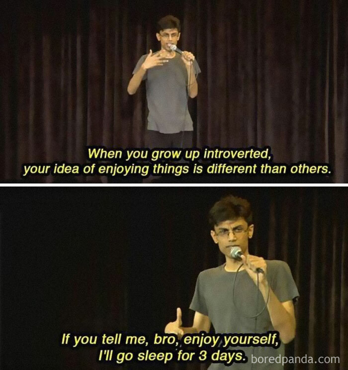 Stand-up comedian on stage sharing a funny introvert meme about enjoying things differently and sleeping for days.