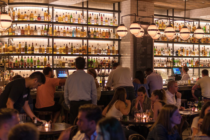 a group of people gathering inside the bar