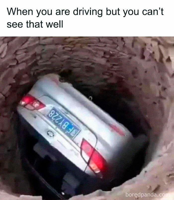 A car humorously stuck vertically in a large pit, illustrating a literal meme.