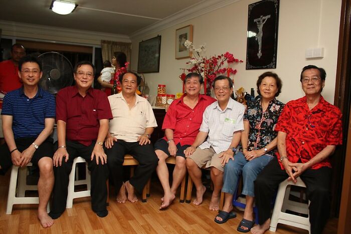 Group of people sitting together indoors, illustrating social customs related to weird laws from around the world.
