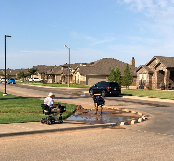 A Neighbor Got A Shovel And Cleared The Mud From The Sidewalk So Another Neighbor In A Scooter Could Make His Way