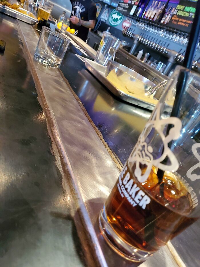 The Bar I'm Sitting At Has A Cold Metal Bar To Keep Your Drinks Cold