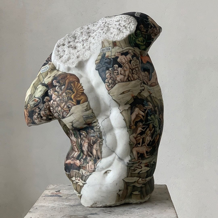 Italian artist's sculpture adorned with colorful tattoos, showcasing detailed artistry on a marble torso.