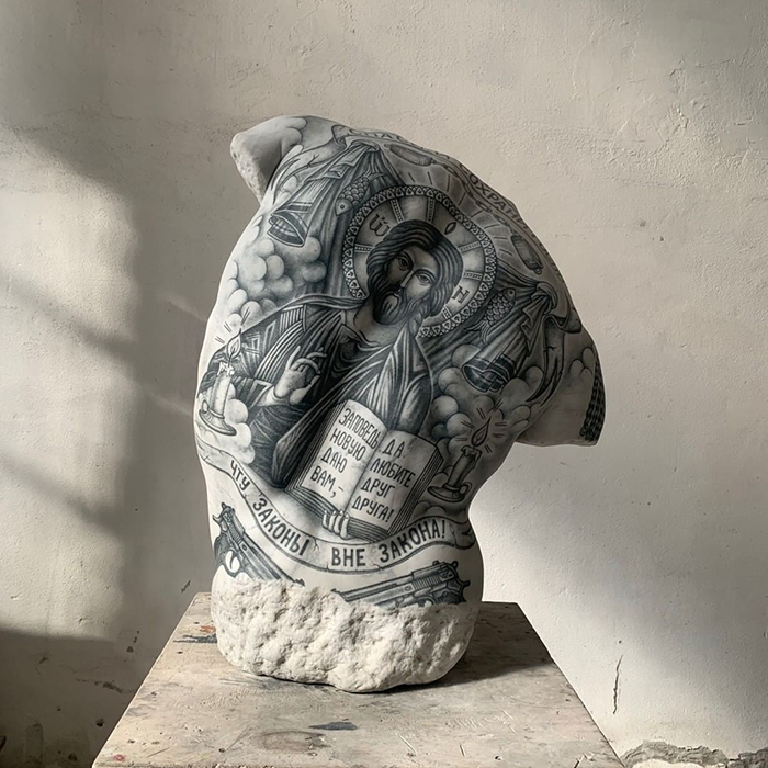 Sculpture by Italian artist featuring intricate tattoo designs on stone, showcasing art beyond skin.