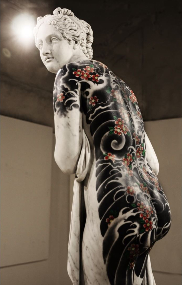 Italian artist's sculpture adorned with intricate tattoo designs.