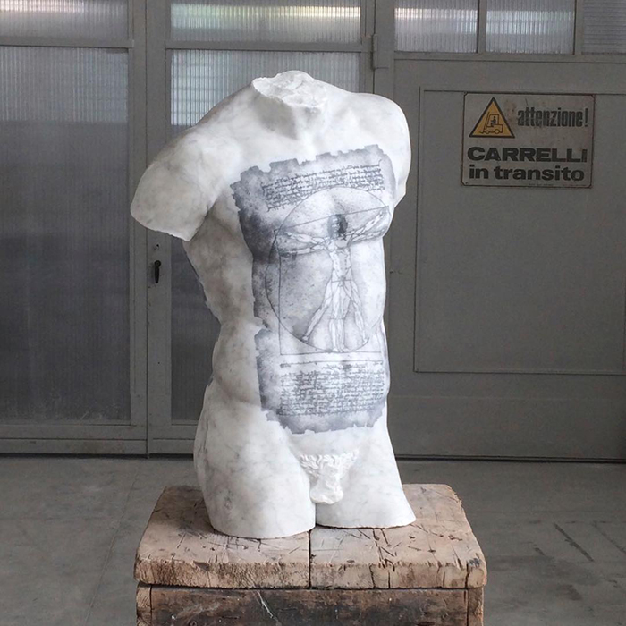 Tattooed sculpture by Italian artist showcasing art beyond traditional skin canvas, featuring Vitruvian Man design.