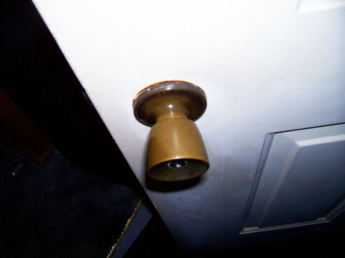 Close-up of a worn door k**b showing specific little things that are so irritating people can’t stand them in a home setting.