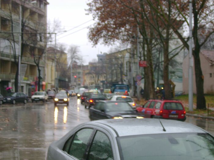 Busy rainy street with traffic jams and blurred cars, illustrating specific little irritating things people can’t stand.