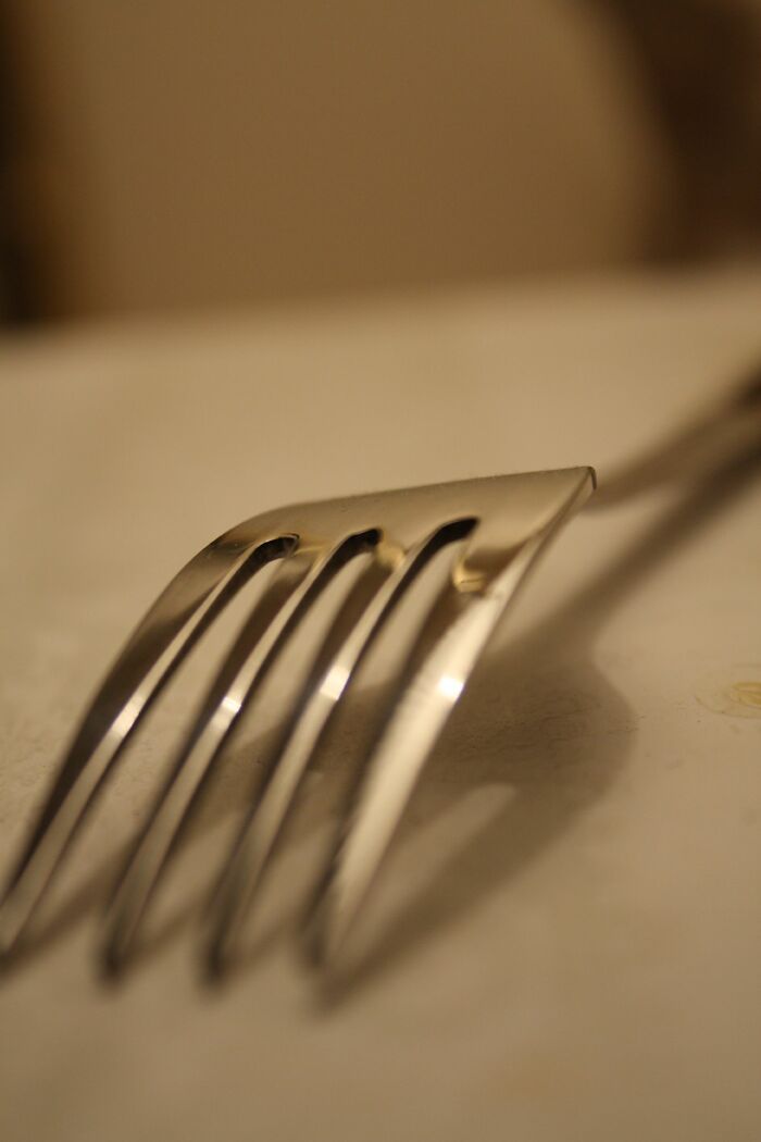 Close-up of a shiny silver fork highlighting one of the specific little things that many people find irritating.