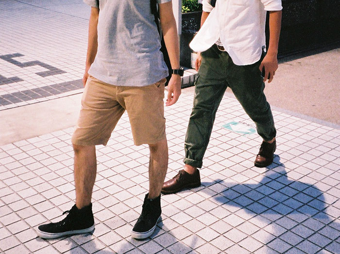 Two people walking on tiled pavement, illustrating specific little things that are irritating and hard to stand.