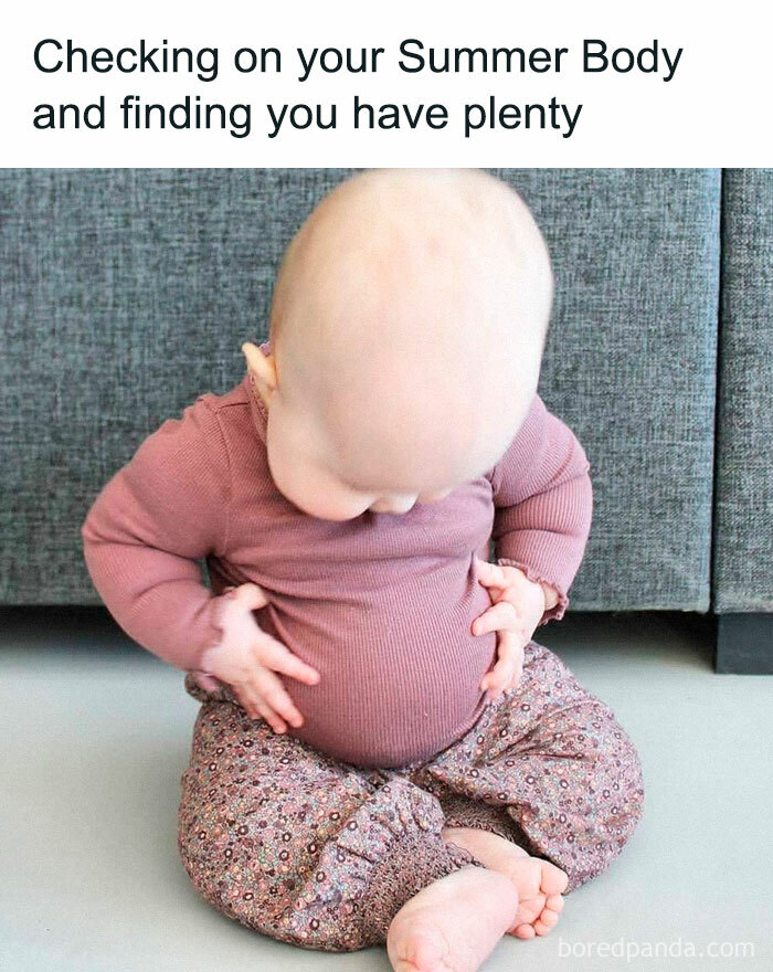 Baby looking at a round belly, sitting on the floor; funny summer meme.