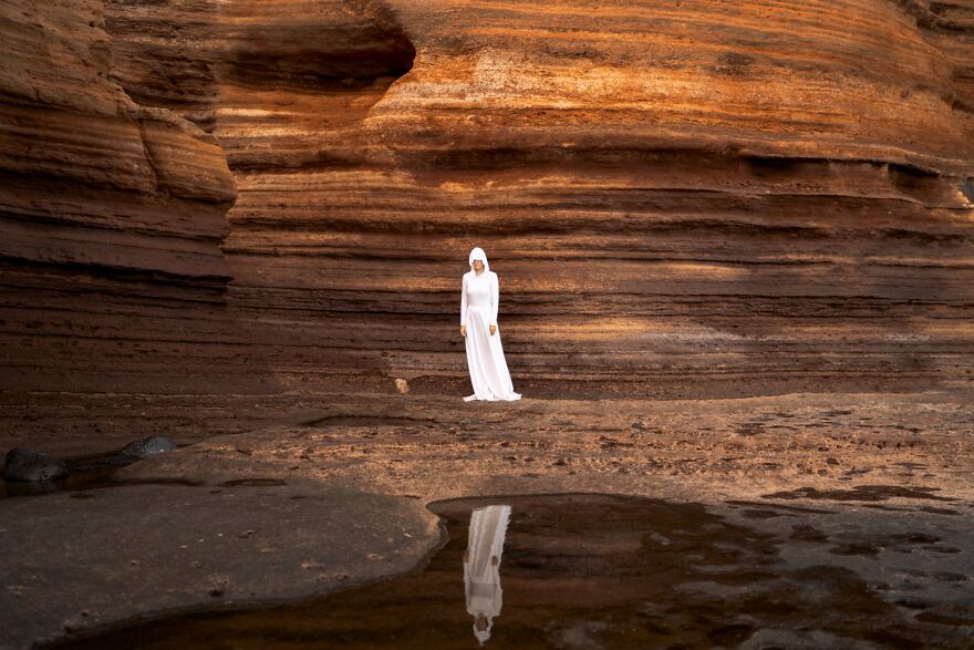 The Ocean Here Was At Reflux, So She Could Climb The Layers Of Rocks And Explore The Cliffy Planet. In Her White Suit She Could Hide, Yet Be Visible At The Same Time. After All, She Had Traveled For So Long That She’d Forgotten The Notion Of Home