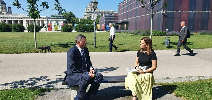President Of Austria Casually Walking His Dog In The Background Of An Ongoing Interview
