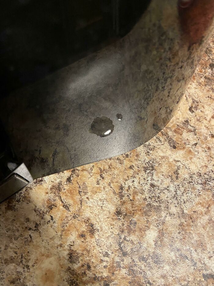 I Can’t See The Actual Drop Of Water On My Countertop, But I See Its Reflection On The Side Of My Coffee Maker