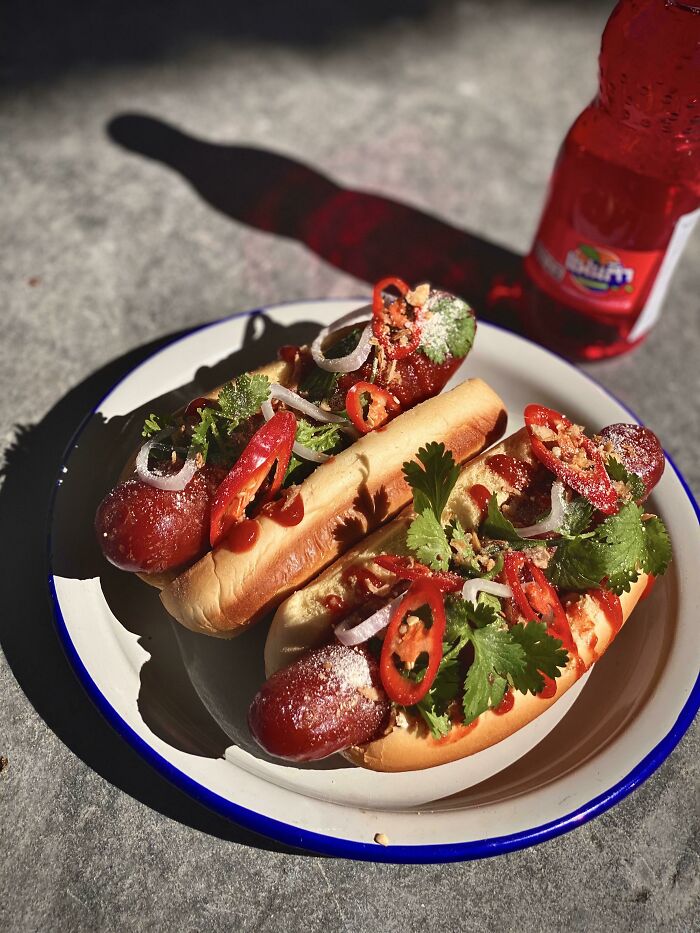 Thai Sweet Sausage, Cilantro, Shallot, Rooster Sauce, Finger Pepper, Toasted Rice, Crispy Shallot On A Potato Roll