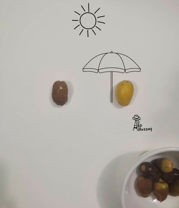 Interactive illustration using everyday items shows two fruit seeds forming a beach scene with umbrella and sun drawings.