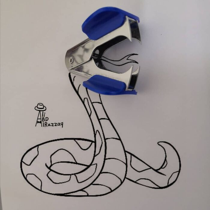Interactive illustration of a snake using a stapler and pen drawing to combine everyday items creatively.
