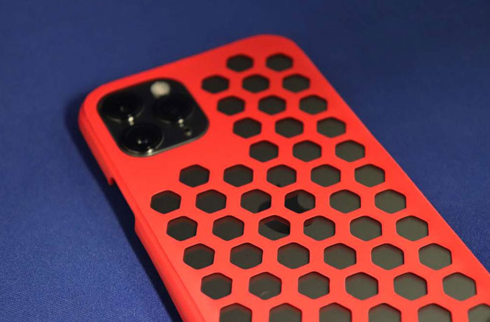 Smartphone with a red hexagonal pattern case on a blue surface, illustrating cool and interesting facts shared online.