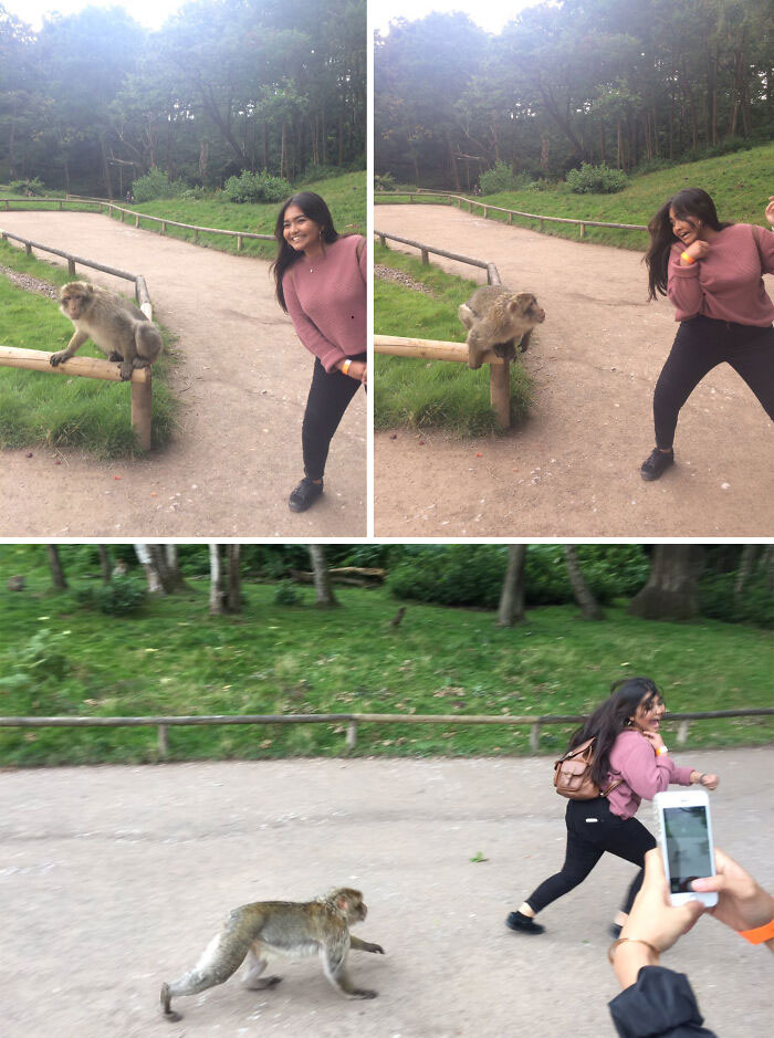 Woman playfully interacting with a funny monkey on a park path.