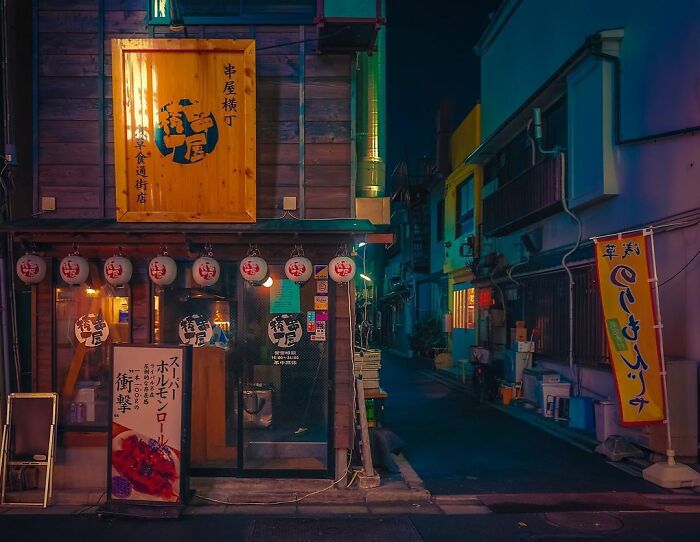 Cozy Japanese street scene at night with traditional lanterns and signage, showcasing the beauty of Japan.
