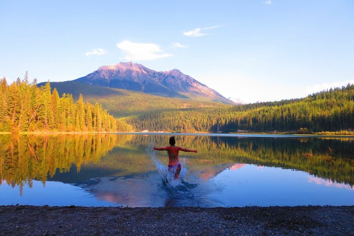 Running Into A Glass-Like White Swan Lake In British Columbia