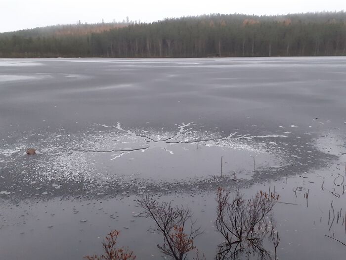 Ice On Lake Cracking In The Shape Of A Snowflake