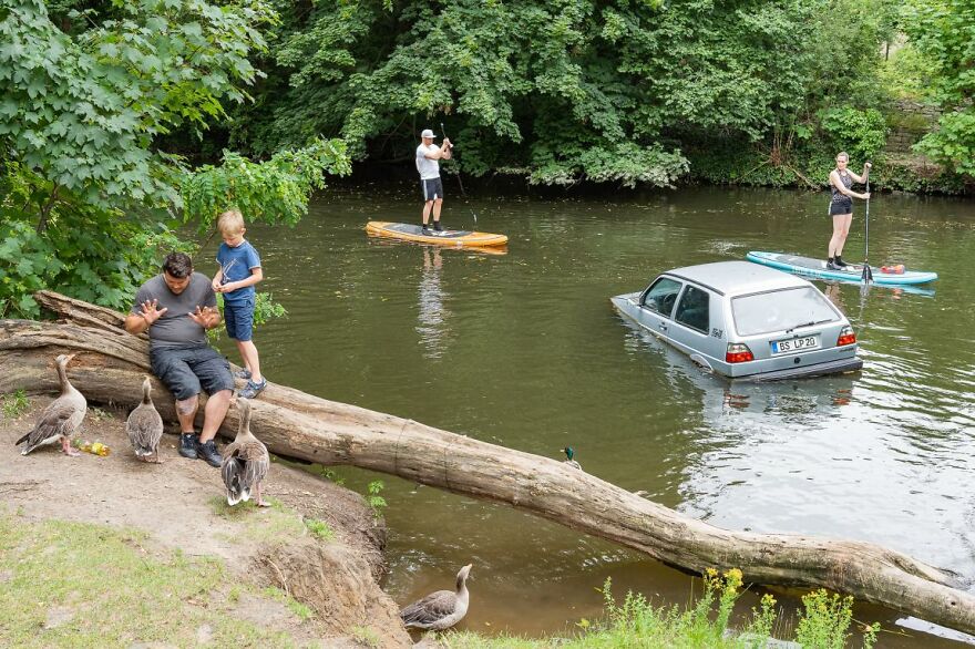 Goose Whisperer, Stand-Up Paddlers And Sunken Car By Thomas Hackenberg