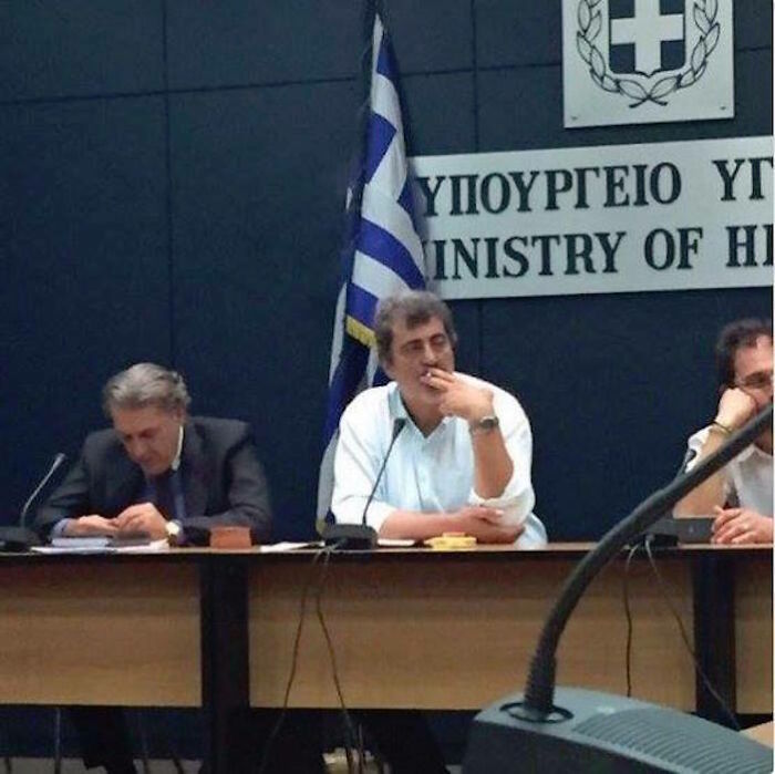 The Greek Deputy Heath Minister, Polakis, Smoking (Illegally) Inside The Ministry Of Health During A No-Tobacco Day Conference