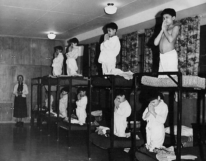 Indigenous Children Forced To Pray To God In A Residential School Ran By The Canadian Government And Catholic Church Between 1930 And 1970, Unknown Location 
