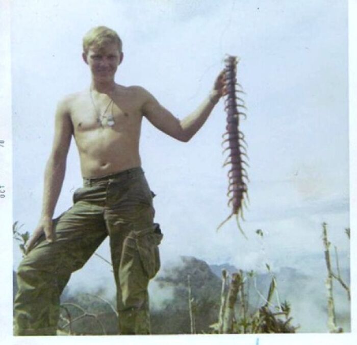 A United States Soldier Holds Up A Jungle Centipede During The Vietnam War, 1967