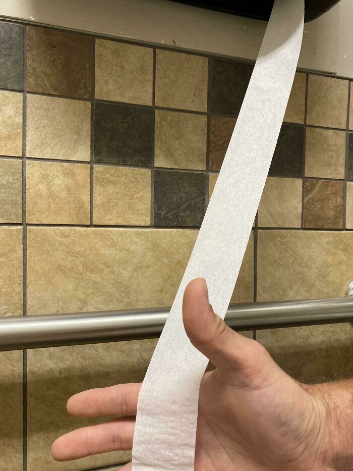 Gas Station Toilet Paper About The Width Of An iPod Shuffle. Hand For Scale