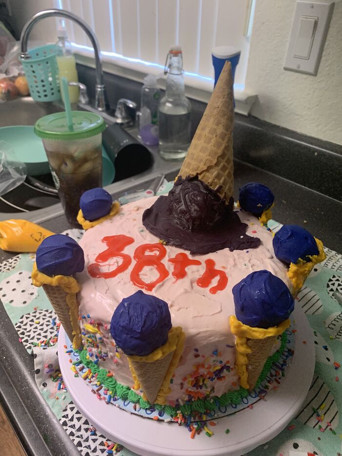 4 Layers Of Cake, 3 Layers Of Ice Cream. The Ice Cream Cones Are Cake Pops. First Attempt To Make Ice Cream Cake (For Hubby). Sorry About My Awful Piping Skills. I Am So Proud!!