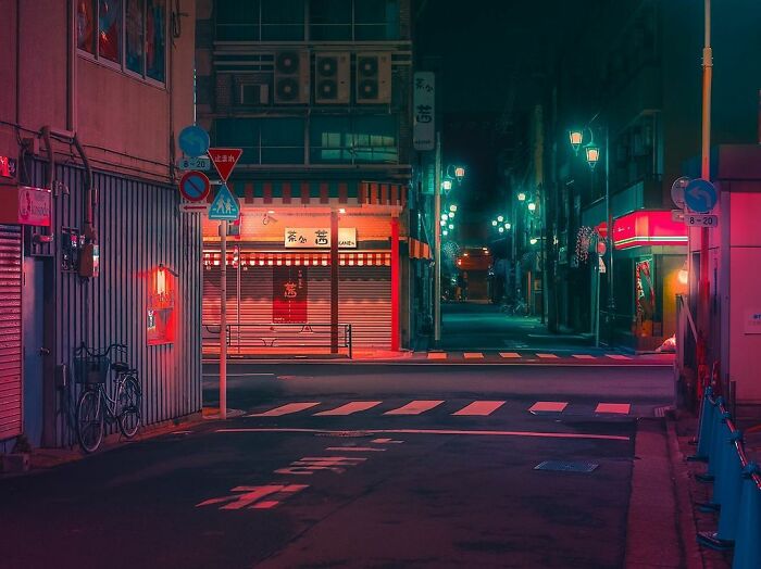 Quiet Japanese street at night with vibrant neon lights, capturing the beauty of Japan in an atmospheric urban scene.