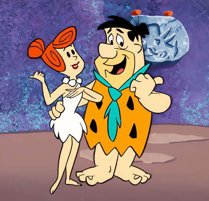 Wilma and Fred Flintstone standing next to each other and smiling