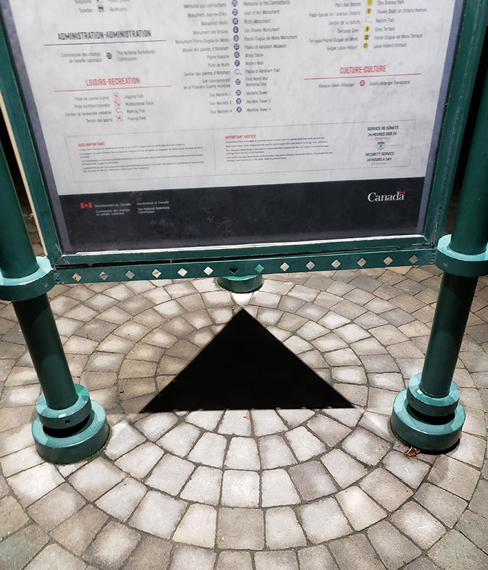 This Triangle Blackhole Created By The Shadow Under An Information Stand