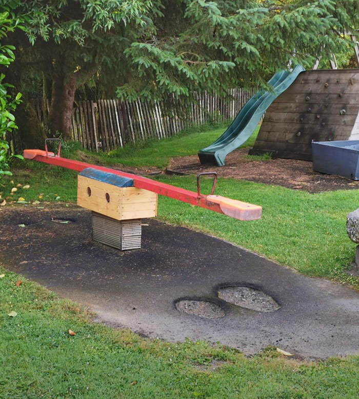 A Seesaw (Teeter-Totter) In My Local Playground Where Thousands Of Little Feet Have Worn Through The Asphalt