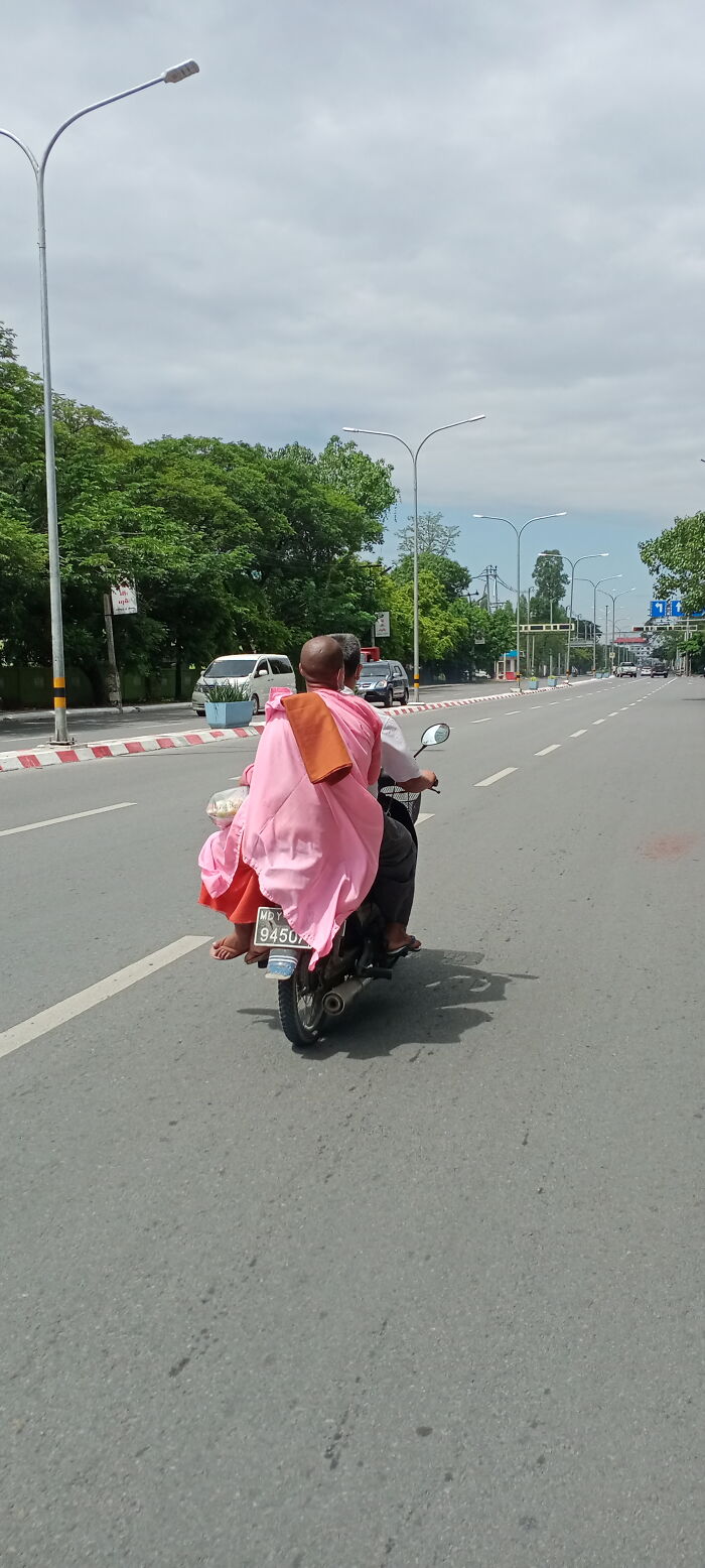 In Mandalay Myanmar, A Nun Hitches A Ride On A Motorcycle