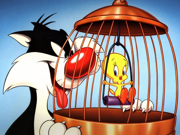 Sylvester looking at Tweety in a cage