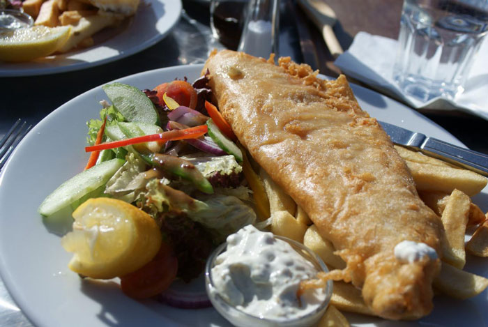 Fish and chips on a plate with salad