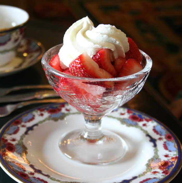 Strawberries and cream in a glass bowl