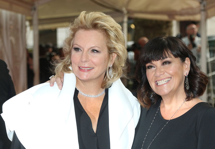 French and Saunders standing next to each other and smiling
