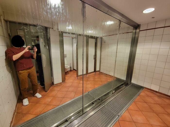 A Urinal In Germany With A Full Length Mirror For Inspecting Other Dude's Junk