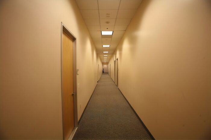 I've Been Walking Trough This Hallway For 3 Hours Until I Finally Saw The End, Should I Continue Or Make The Walk Back? Doors On Sides Are All Just Dimly Lit Office Closets