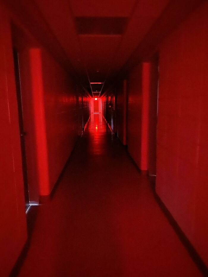 I Walked Out Of My Room And Was Greeted With This. The Only Light Is From The Exit Signs At Either End Of The Hall, But Walking Towards Them Doesn’t Get You Any Closer
